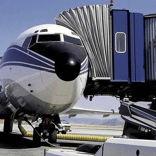 Foto de un avión con una pasarela de embarque de pasajeros llamada fingers